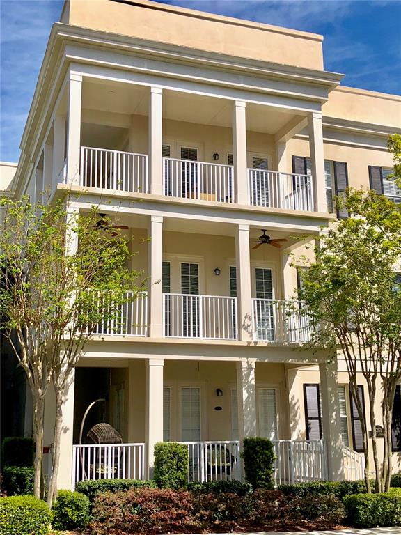 A three-story beige building features stacked balconies with white railings and ceiling fans — 4281 ANISSA AVENUE UNIT 11, ORLANDO, FL