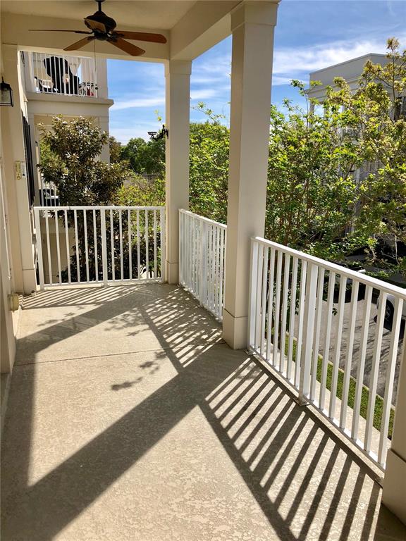 A covered balcony with a ceiling fan, white railings, and a concrete floor — 4281 ANISSA AVENUE UNIT 11, ORLANDO, FL