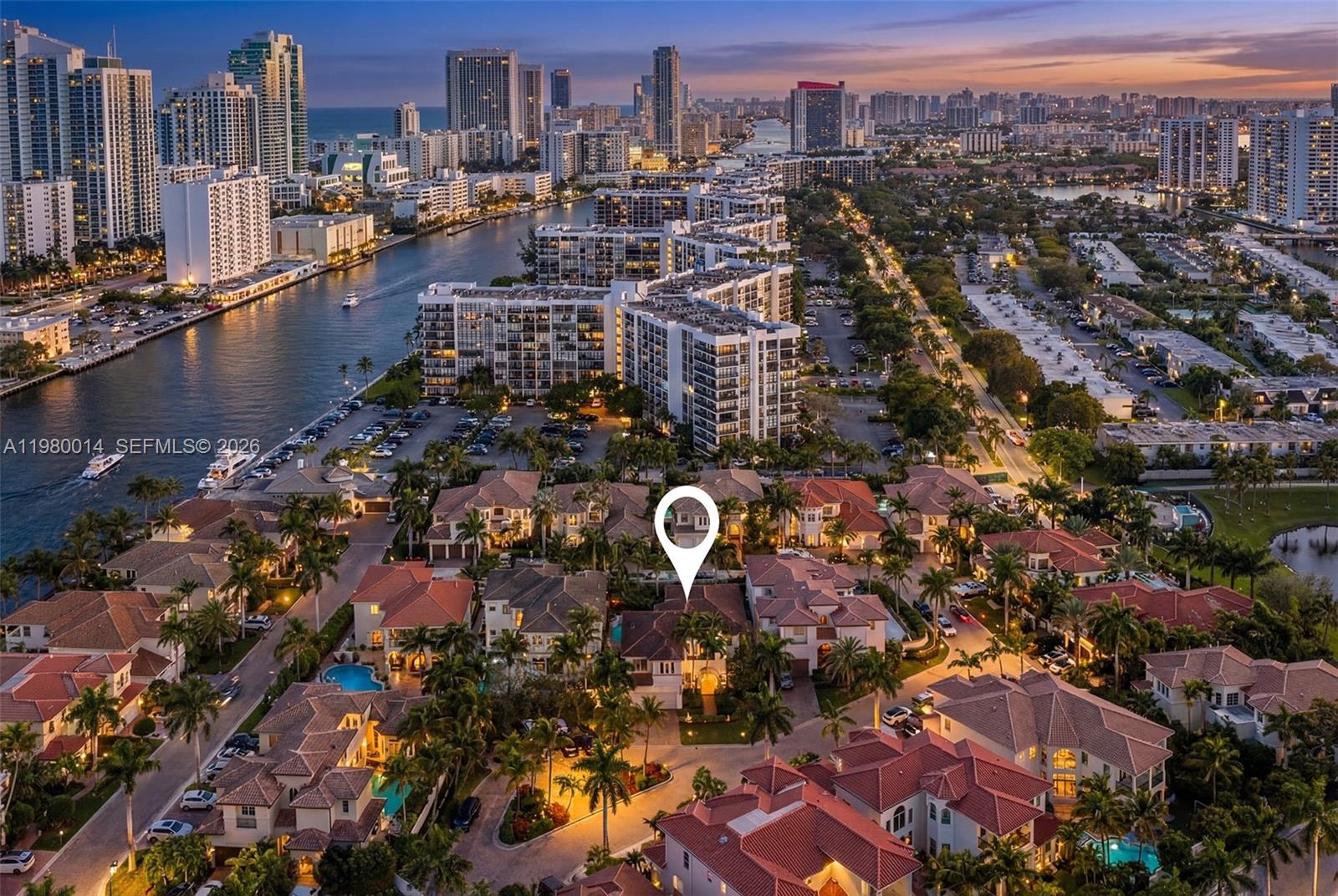 An aerial view shows a residential neighborhood with houses, swimming pools, and a nearby waterway — 822 Meridian Ln, Hollywood FL 33019, HOLLYWOOD, FL