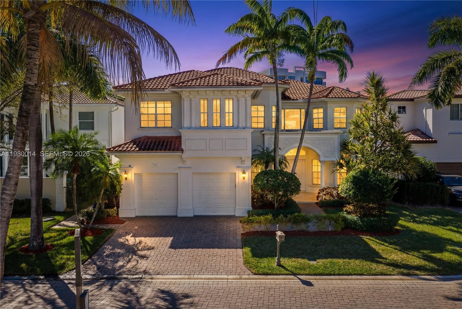 A two-story Mediterranean-style house features a tiled roof, a two-car garage, and palm trees — 822 Meridian Ln, Hollywood FL 33019, HOLLYWOOD, FL