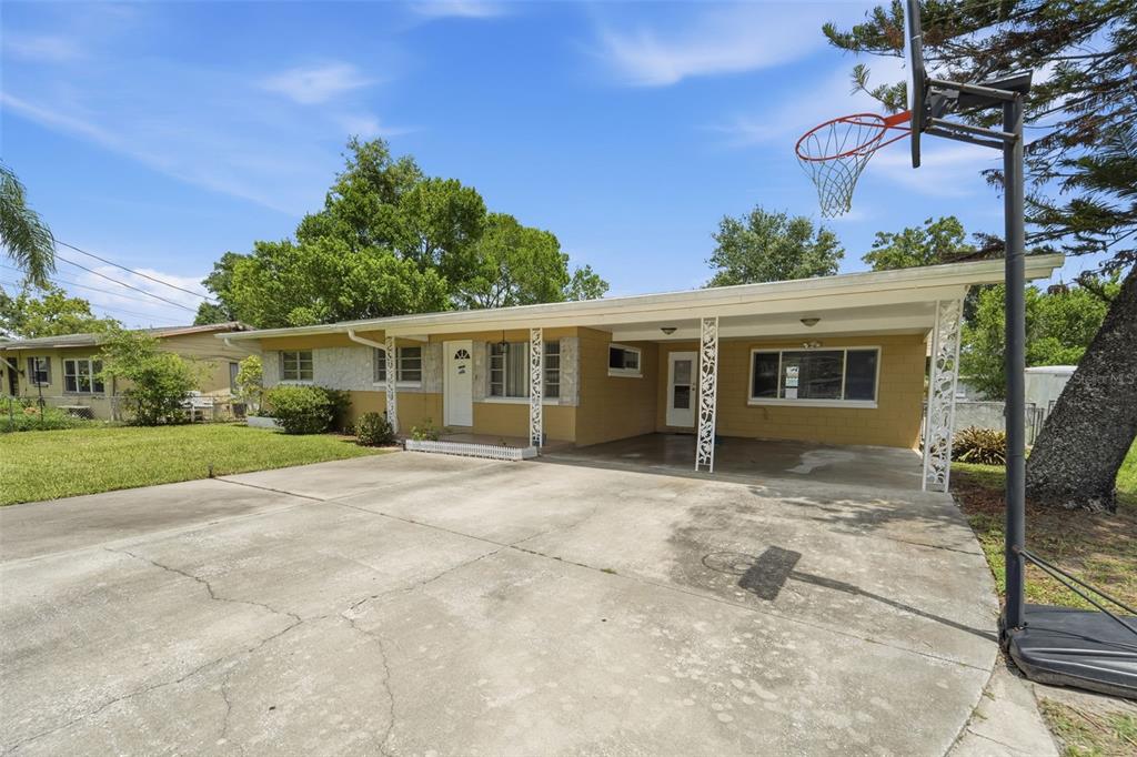A single-story house with a concrete driveway, a carport, and a basketball hoop — 123 E LAKE MARY DRIVE, ORLANDO, FL
