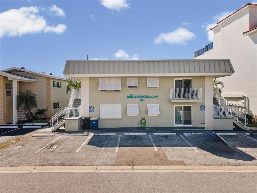 A two-story apartment building with a parking lot in front and exterior staircases — 185 BRIGHTWATER DRIVE UNIT 6, CLEARWATER BEACH, FL