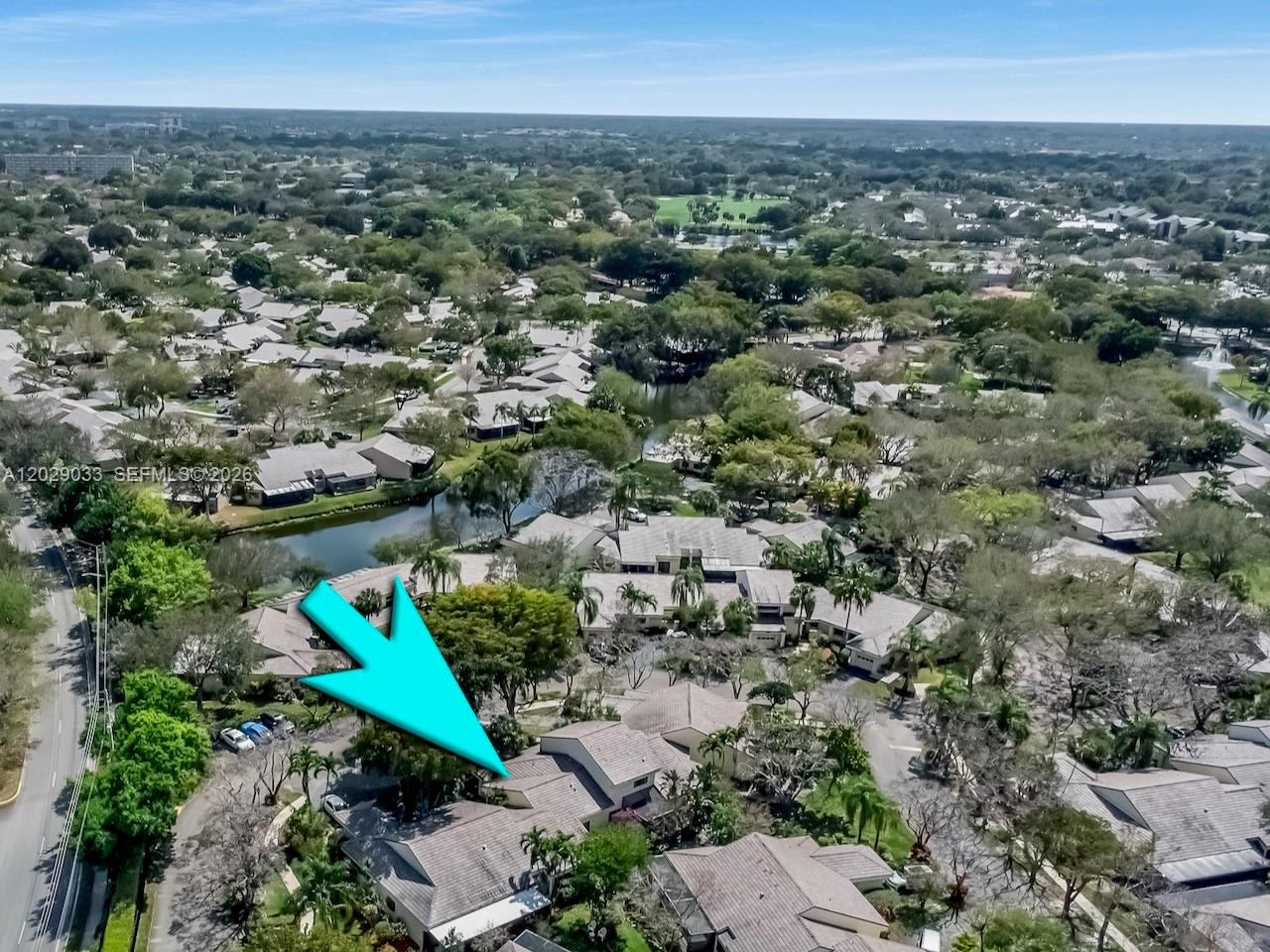 A single-story residential building with a tiled roof, stucco exterior, and a gated courtyard entrance — 349 NW 94th Ter, Plantation FL 33324, PLANTATION, FL