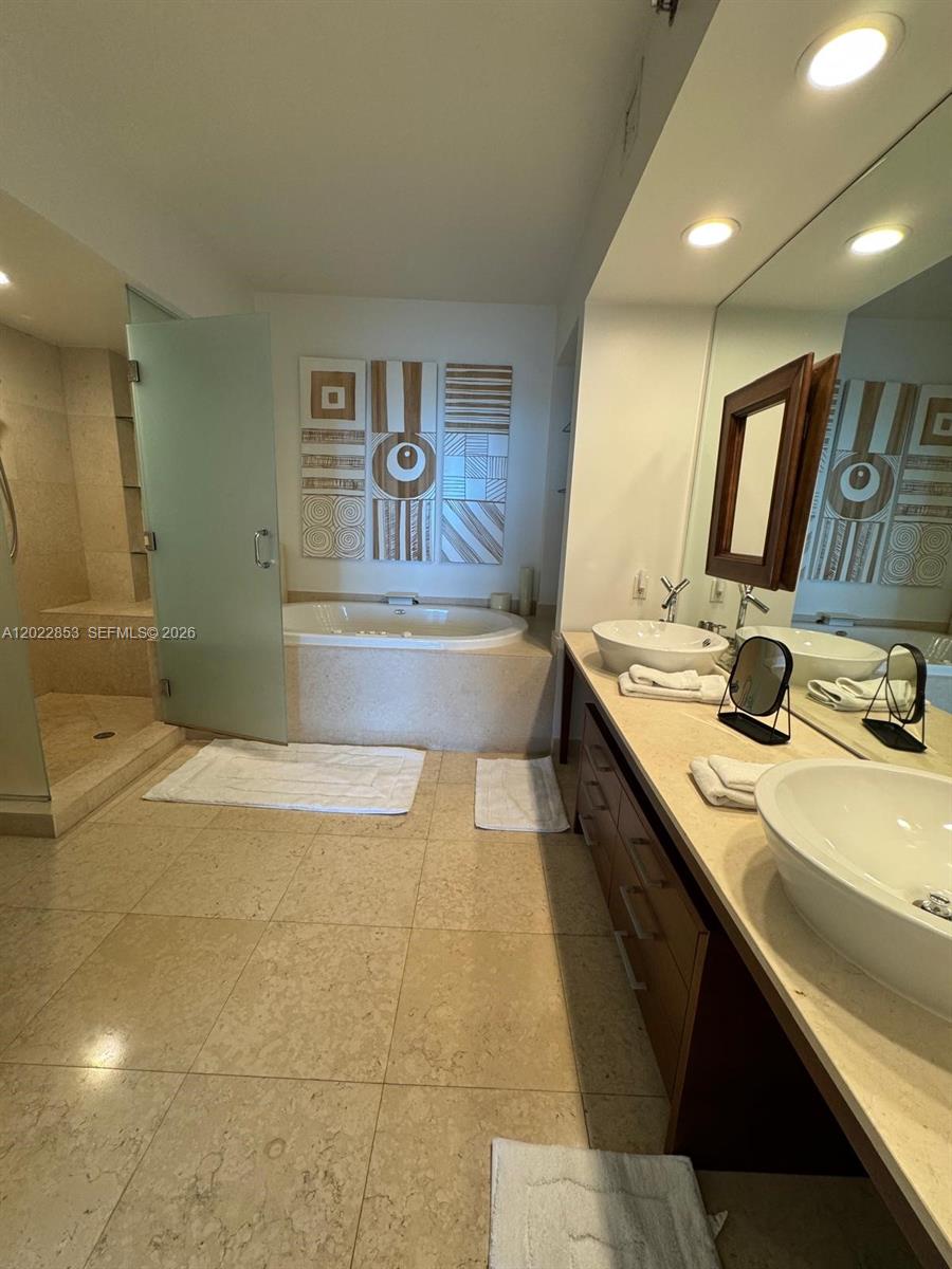 A bathroom features a soaking tub, a glass-enclosed shower, and a double vanity — 450 Alton Rd # 3505, Miami Beach FL 33139, MIAMI BEACH, FL