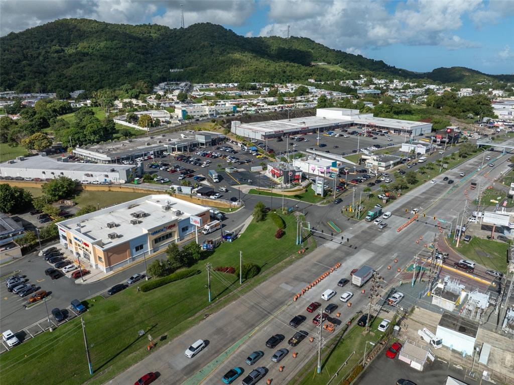 An aerial view shows a commercial shopping center with parking lots and a busy road — carretera 3 , km 45.5 CARRETERA 3, FAJARDO, PR