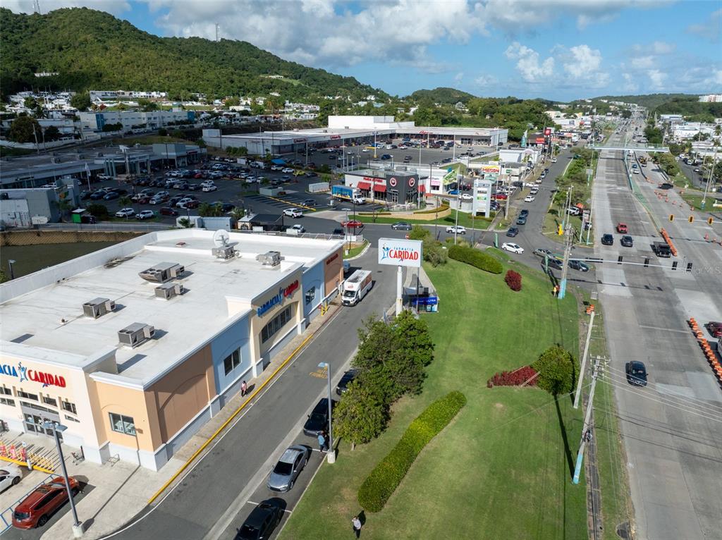 An aerial view shows a commercial building with a parking lot and a nearby highway — carretera 3 , km 45.5 CARRETERA 3, FAJARDO, PR