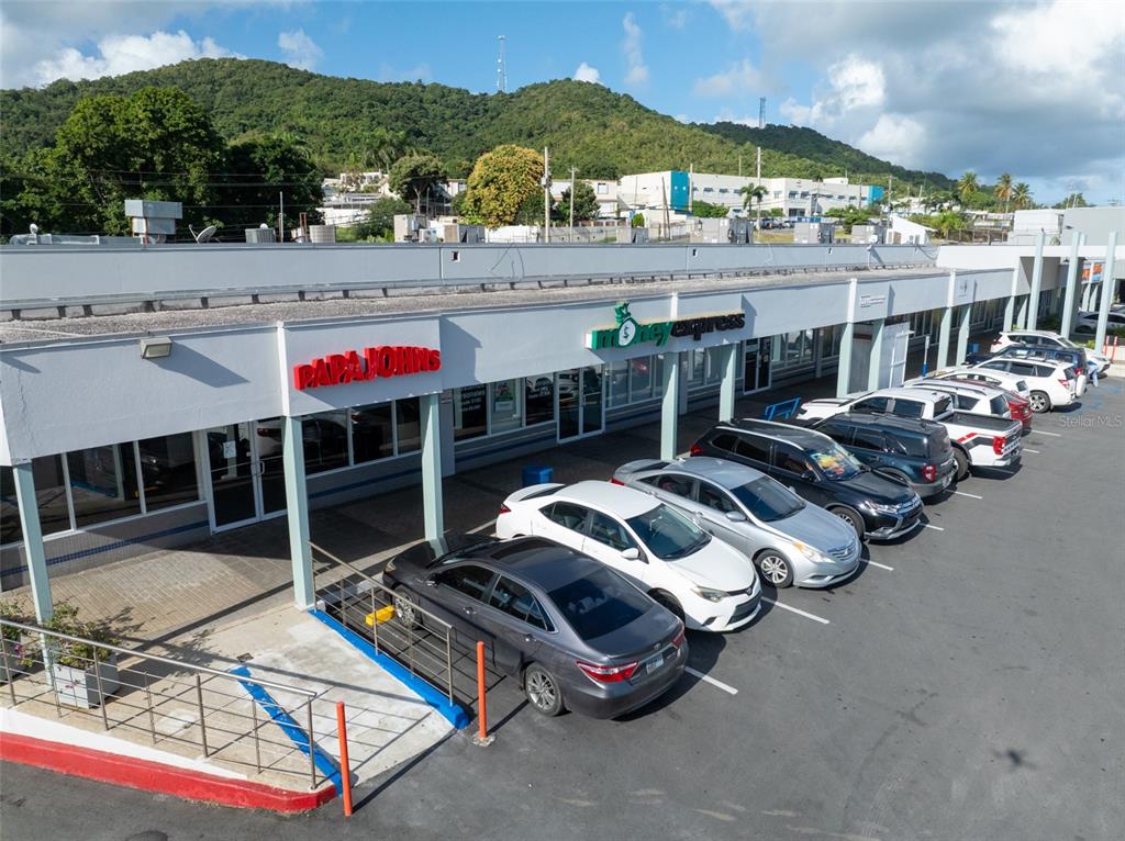 An exterior view of a strip mall featuring a Papa Johns and a Money Express — carretera 3 , km 45.5 CARRETERA 3, FAJARDO, PR