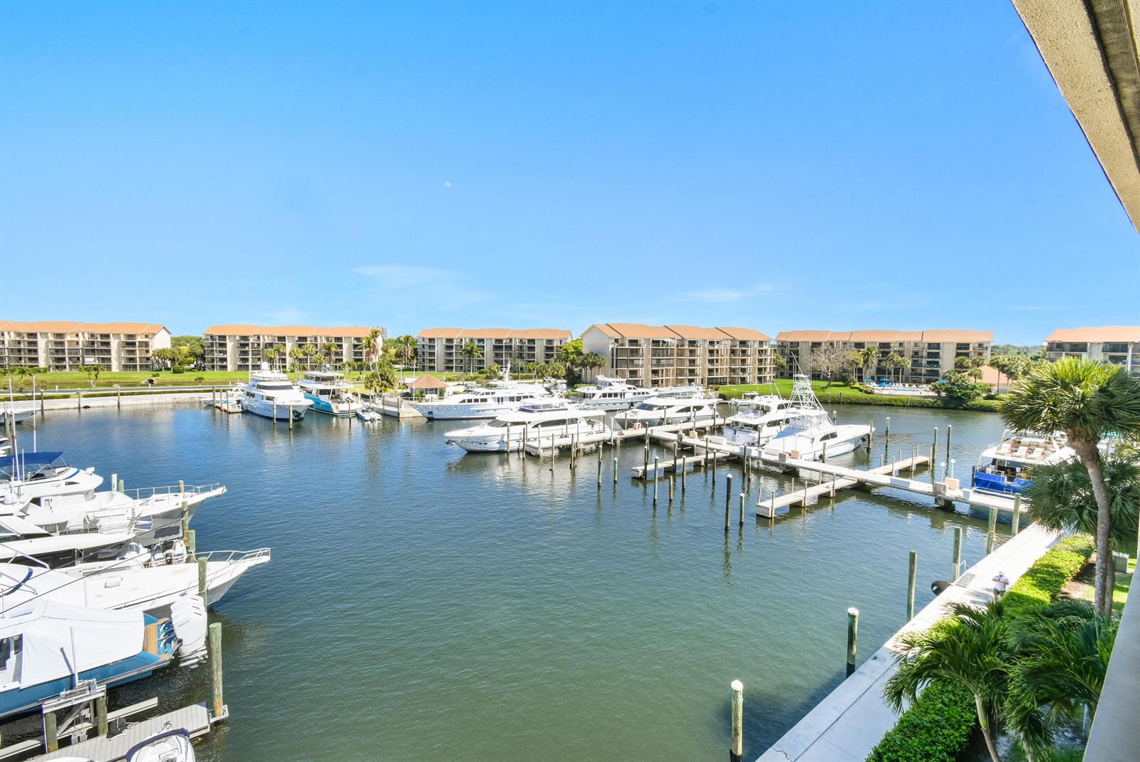 An elevated view shows a marina filled with yachts in front of several apartment buildings — 2401 Marina Isle Way # 503, Jupiter FL 33477, JUPITER, FL
