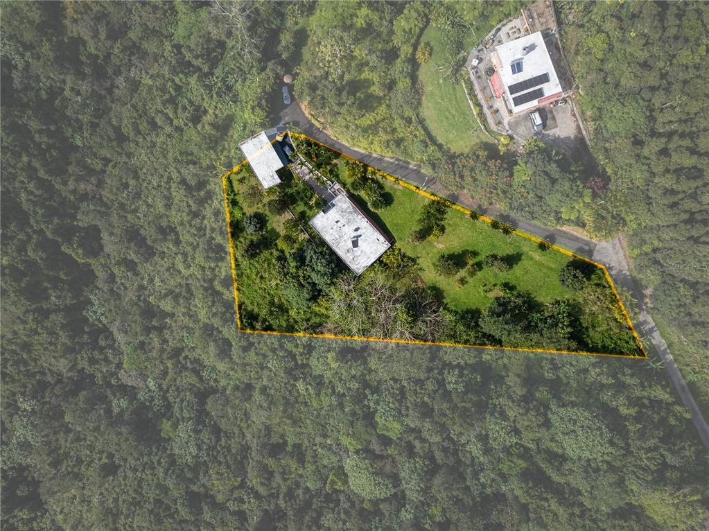 An aerial view shows a house and a detached structure on a large, grassy lot — Carretera 715 KILOMETRO 3.7, CAYEY, PR