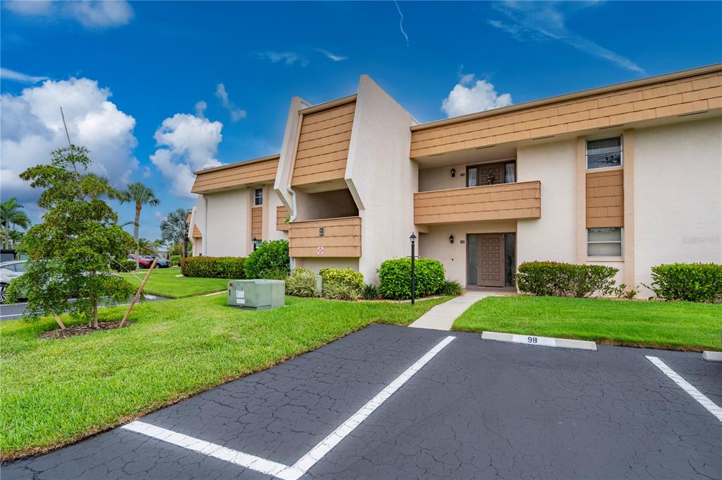 A two-story apartment building exterior with a parking space marked 9B in the foreground — 1080 BAL HARBOR BOULEVARD UNIT 9D, PUNTA GORDA, FL