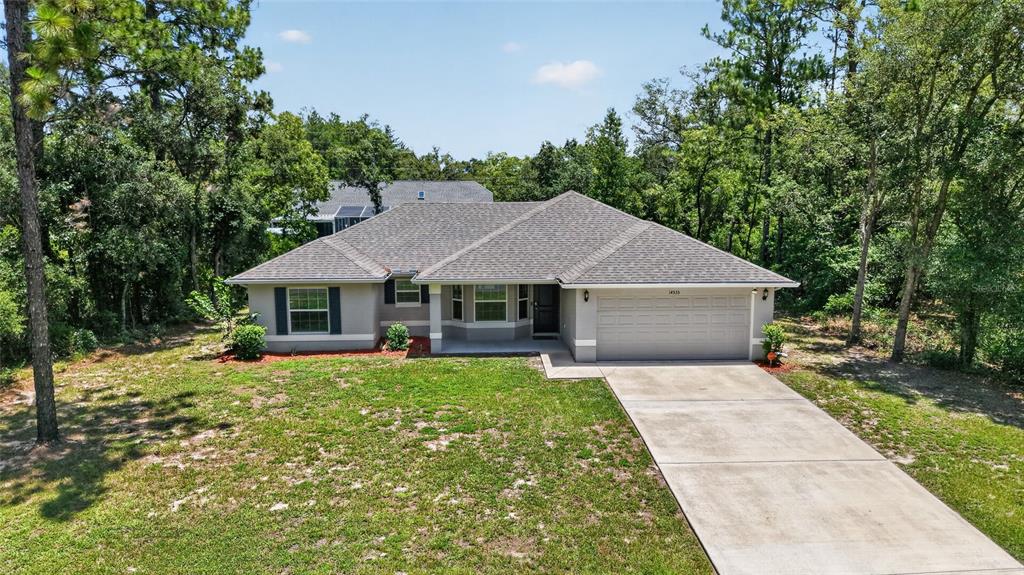 A single-story house with a gray exterior, a two-car garage, and a concrete driveway — 14535 SW 68TH TERRACE, OCALA, FL