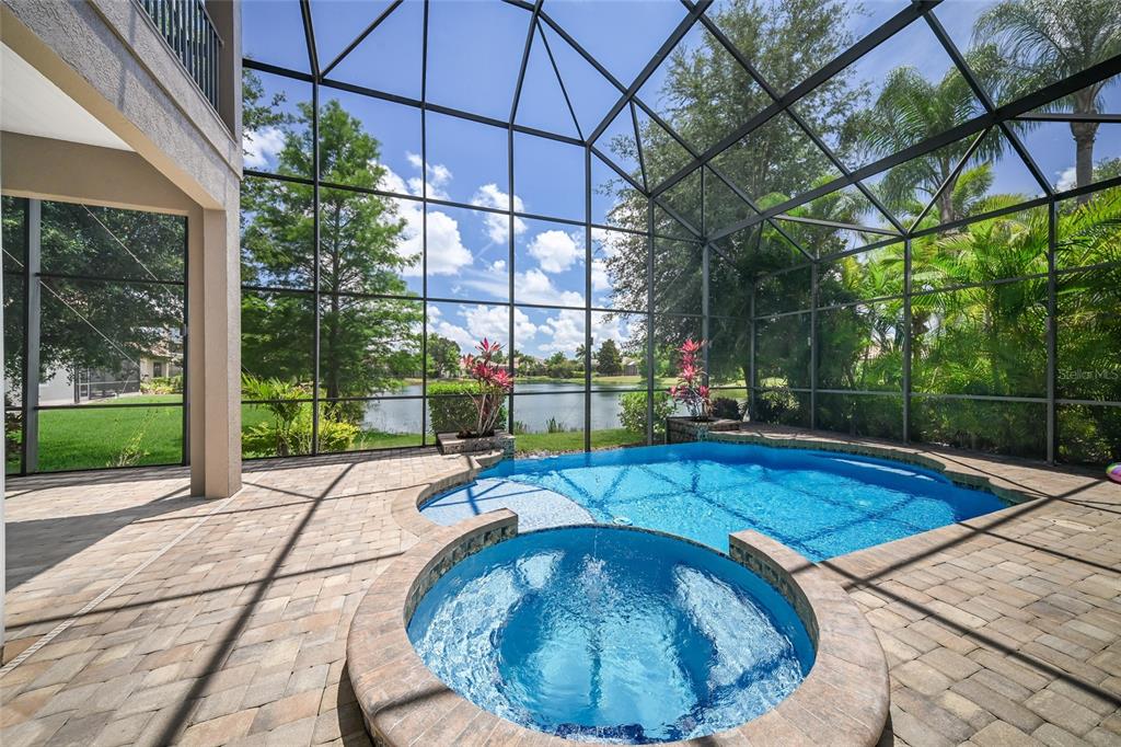 An entryway with tiled floors and two white columns opens into a bright living area — 14806 BOWFIN TERRACE, LAKEWOOD RANCH, FL