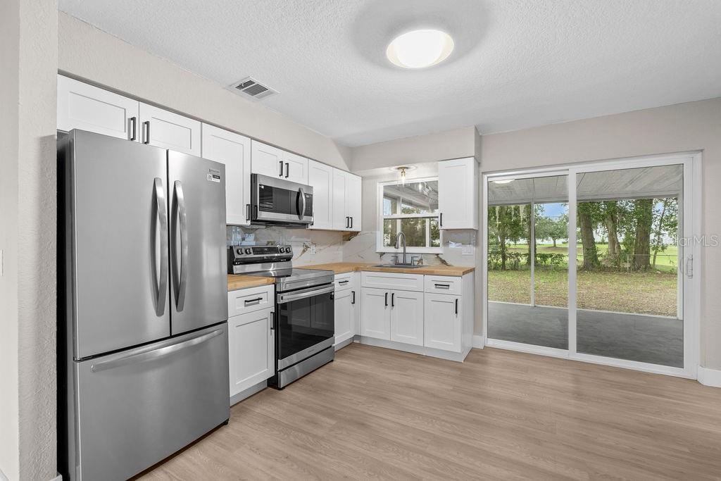 An aerial view shows a single-story house with a yard and driveway on a lot — 5399 MUSTANG WAY, ORLANDO, FL