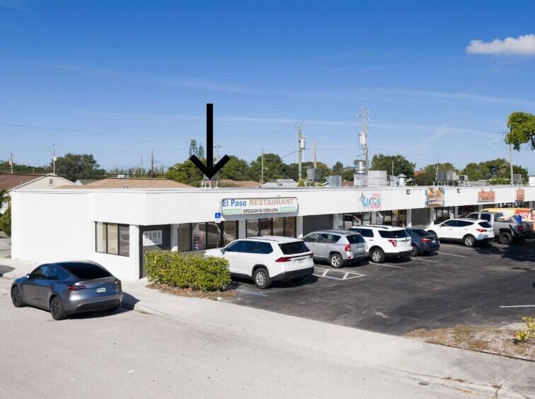 An exterior view of a single-story commercial strip mall with a parking lot in front — 2101 N Dixie Highway # 2101, FL 33460, FL
