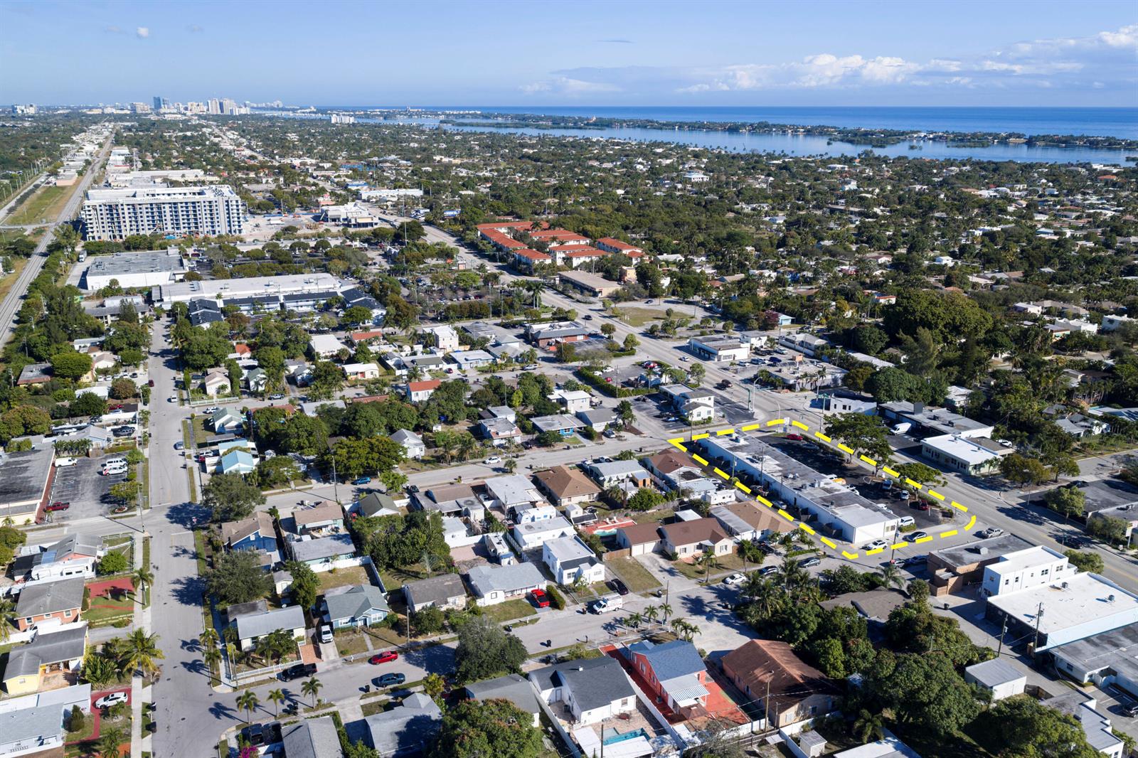 An aerial view shows a commercial building highlighted in yellow amidst a suburban neighborhood — 2101 N Dixie Highway # 2101, FL 33460, FL