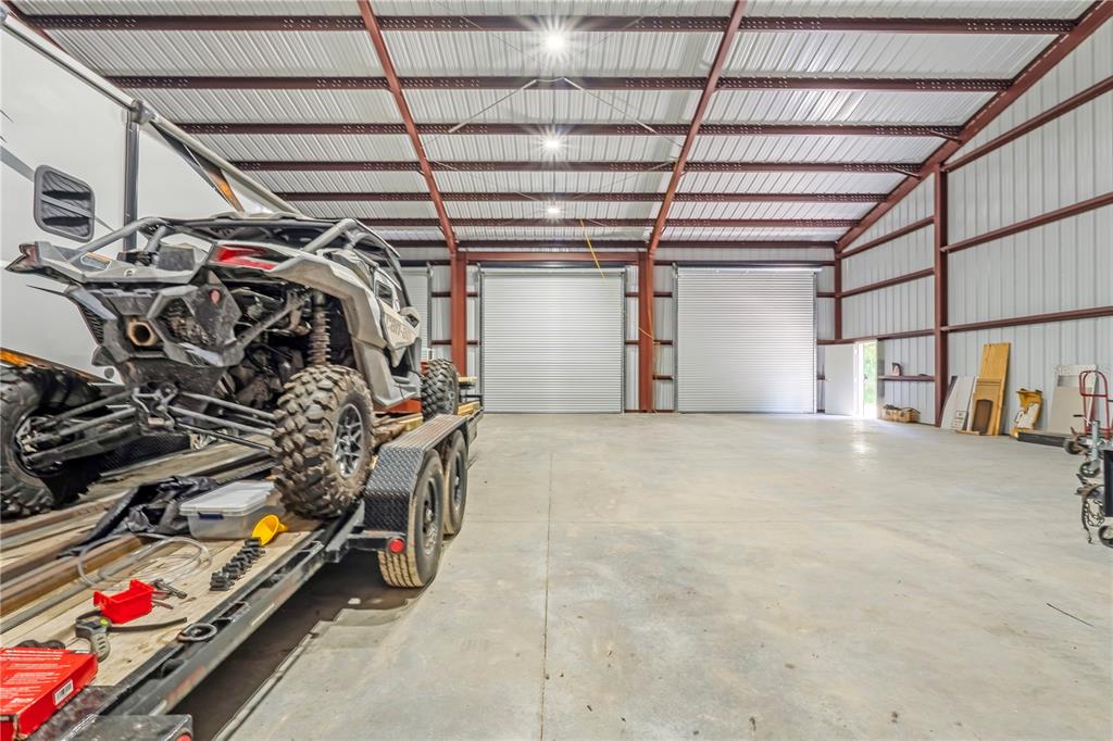 An aerial view of a detached three-car metal garage situated on a grassy lot — 2287 N SPRING GARDEN AVENUE, DELAND, FL