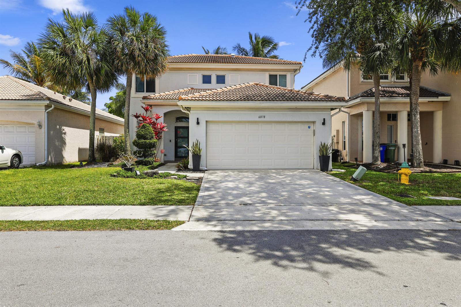 A two-story house with a white stucco facade, tiled roof, and a two-car garage — 6878 NW 33rd Street, Margate FL 33063, MARGATE, FL