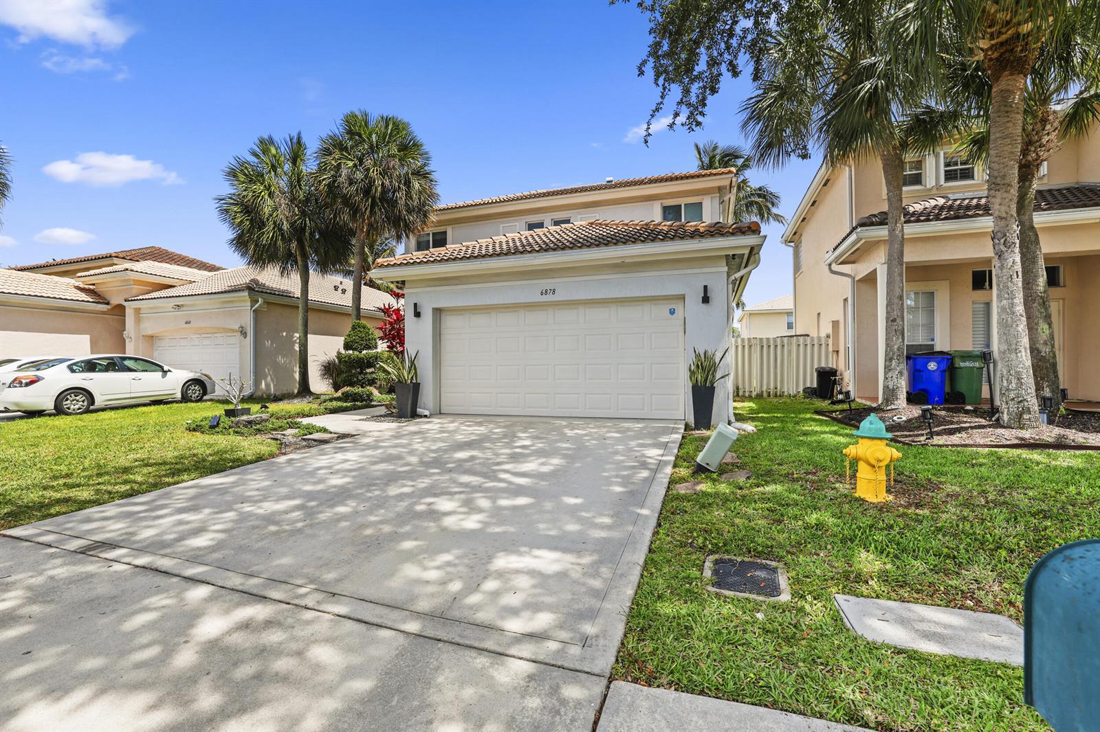 A two-story house with a concrete driveway, a two-car garage, and a yellow fire hydrant — 6878 NW 33rd Street, Margate FL 33063, MARGATE, FL