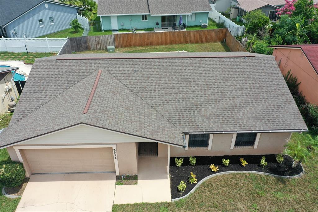 An aerial view shows the shingled roof and front exterior of a single-story suburban house — 2311 TOWERBRIDGE STREET, ORLANDO, FL