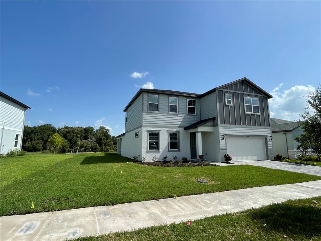 A two-story house with light gray siding and a white stucco lower level — 34286 EVERGREEN HILL COURT, WESLEY CHAPEL, FL