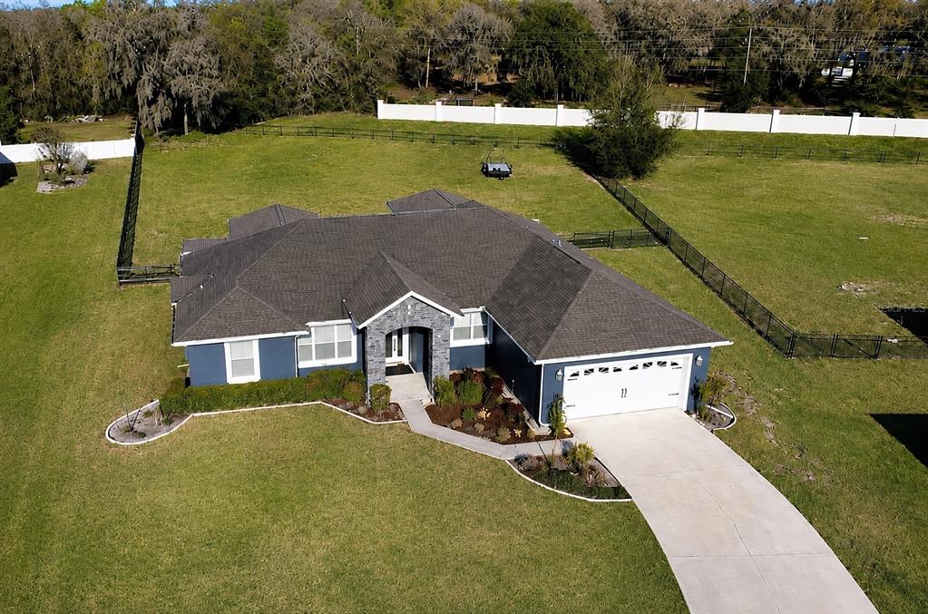 An aerial view of a blue single-story house with a gray roof and large yard — 360 NW 113TH CIRCLE, OCALA, FL
