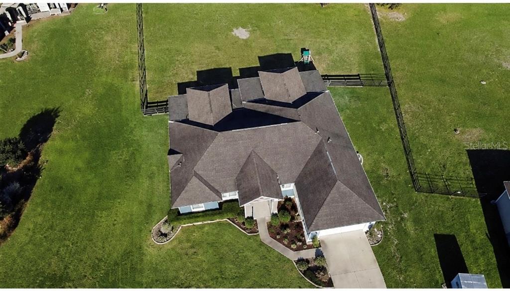 An aerial view shows a single-story house with a shingled roof and a fenced yard — 360 NW 113TH CIRCLE, OCALA, FL