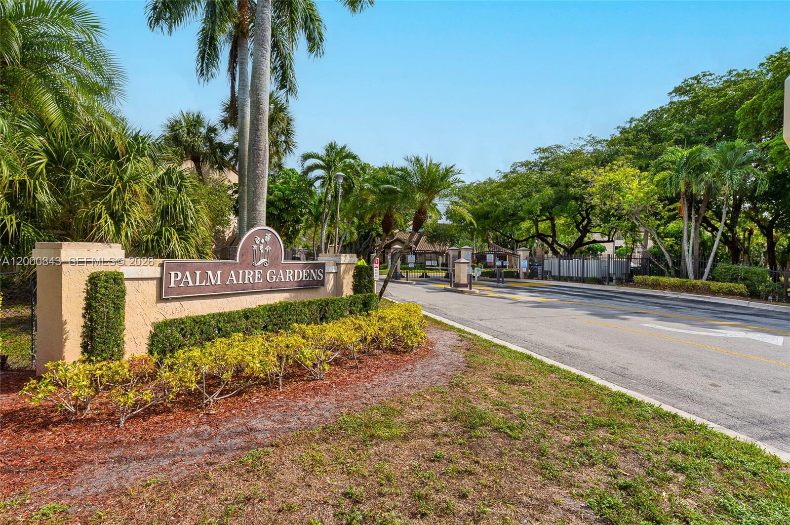 A sign for Palm Aire Gardens stands at the entrance to a gated community — 4581 W Mcnab Rd # 28, Pompano Beach FL 33069, POMPANO BEACH, FL