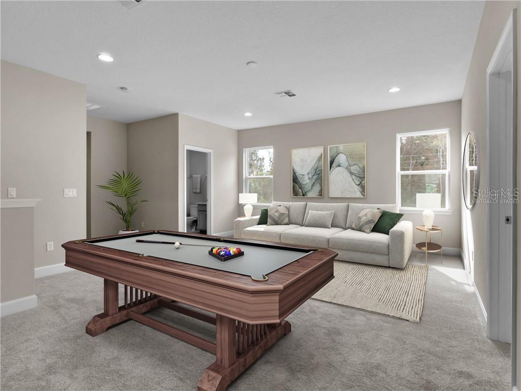 This virtually staged game room features a pool table, a sofa, and neutral carpeting — 913 TALON PLACE, WINTER SPRINGS, FL