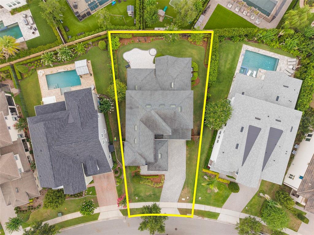 Aerial view of a residential property with a house, driveway, and backyard lawn — 9462 BECKER COURT, ORLANDO, FL