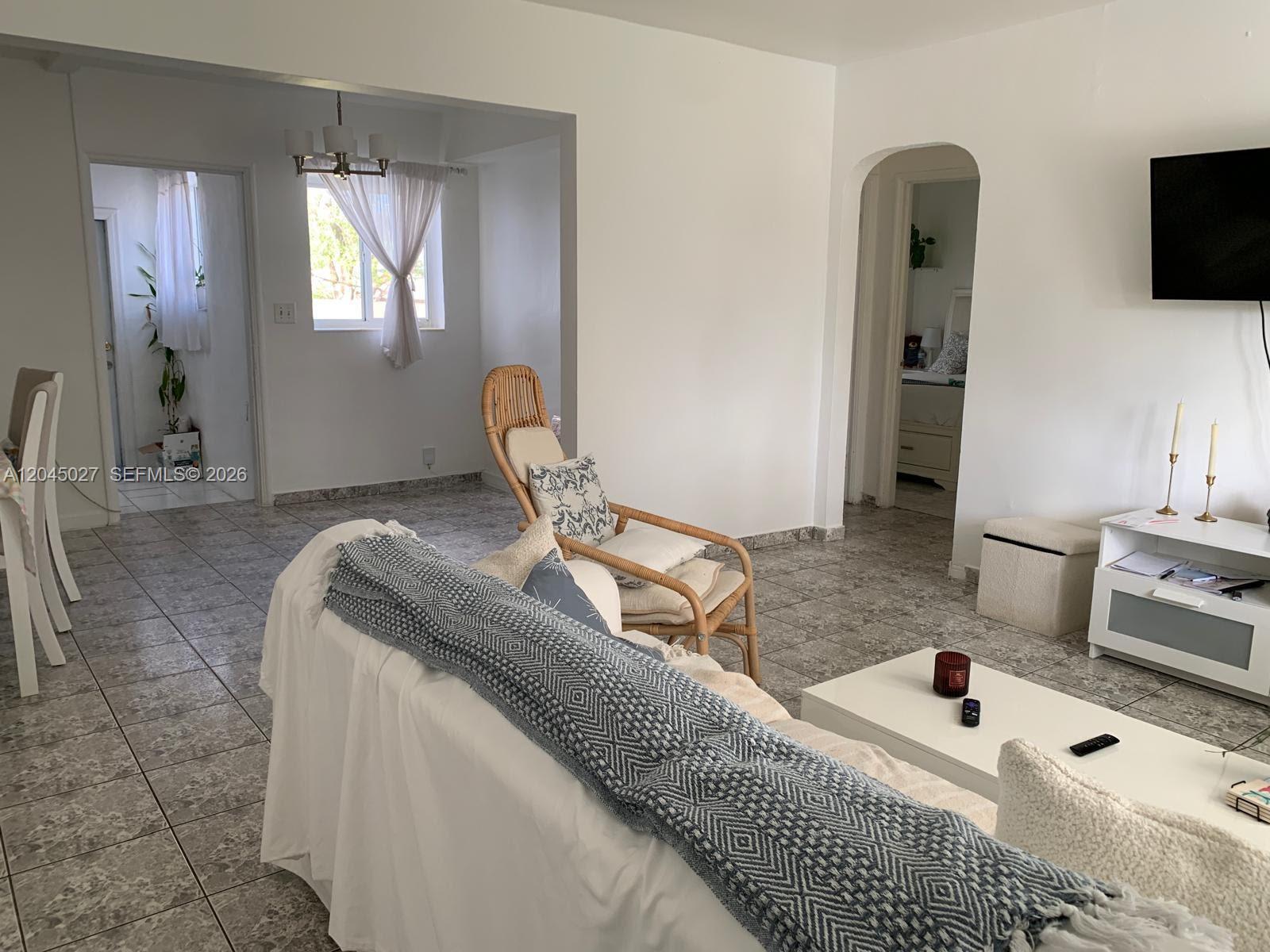 A room with white walls, tiled flooring, and an arched doorway leading to another area — 2131 Arthur St # 0, Hollywood FL 33020, HOLLYWOOD, FL