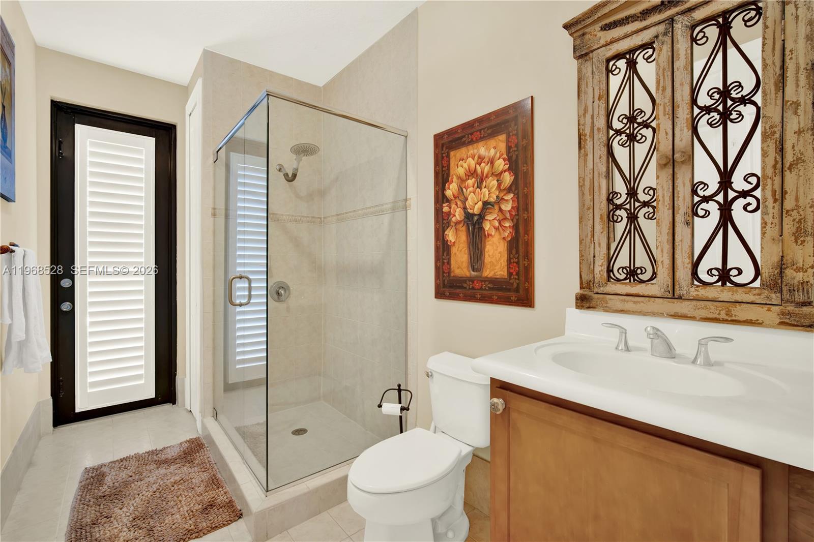 A kitchen features wood cabinets, stainless steel appliances, a central island, and arched architectural columns — 7823 SW 195th Ter, Cutler Bay FL 33157, CUTLER BAY, FL