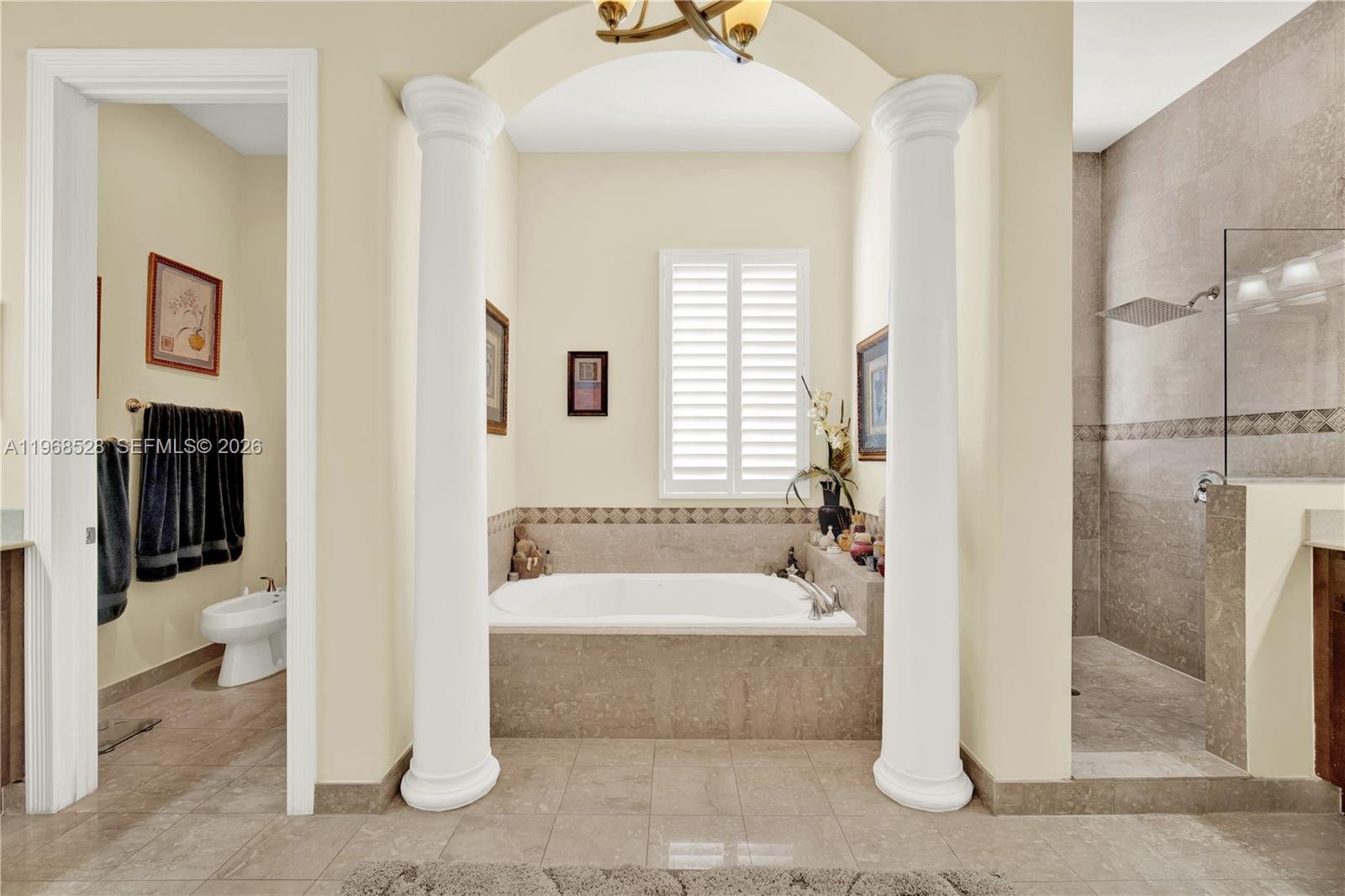 A kitchen features wooden cabinets, a breakfast bar with four stools, and white columns — 7823 SW 195th Ter, Cutler Bay FL 33157, CUTLER BAY, FL