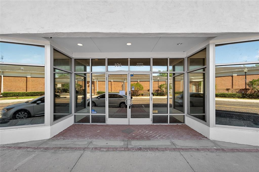 The exterior entrance of a commercial building features glass doors and large display windows — 106 N EVERS STREET, PLANT CITY, FL