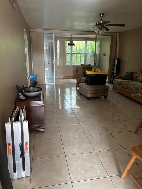 A two-story apartment building features green stucco walls, white railings, and a concrete walkway — 1433 S BELCHER ROAD UNIT G1, CLEARWATER, FL