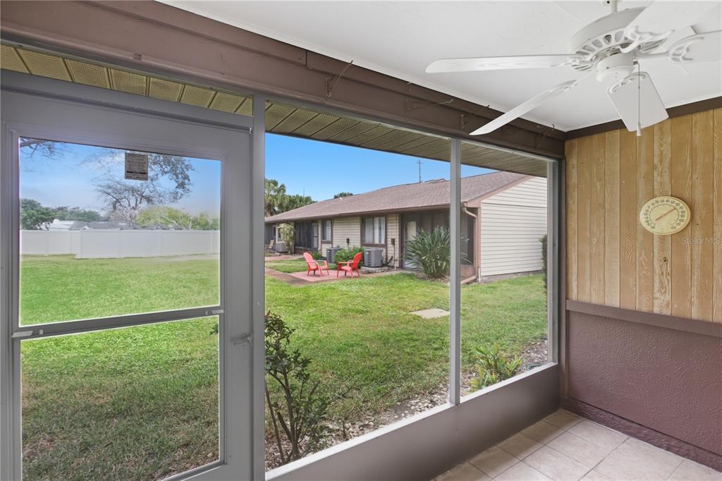 A single-story house exterior features beige siding, a palm tree, and a concrete walkway — 5908 36TH AVENUE CIRCLE W, BRADENTON, FL