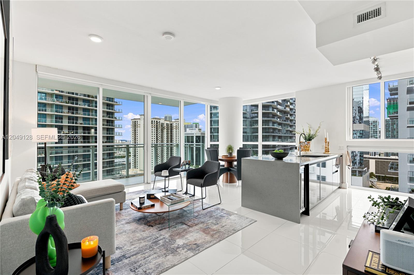 A modern open-concept living room and kitchen with floor-to-ceiling windows and city views — 1080 Brickell Ave # 2609, Miami FL 33131, MIAMI, FL
