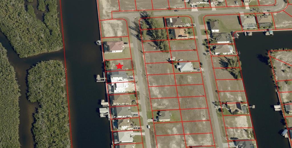 This aerial map shows a residential neighborhood with waterfront lots and a red star marker — 3002 NW 47TH AVENUE, CAPE CORAL, FL