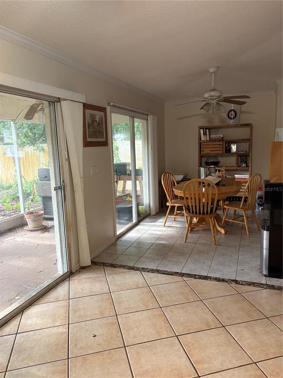 A dining area features tile flooring, a wooden table with chairs, and sliding glass patio doors — 3743 WAKE AVENUE, SARASOTA, FL