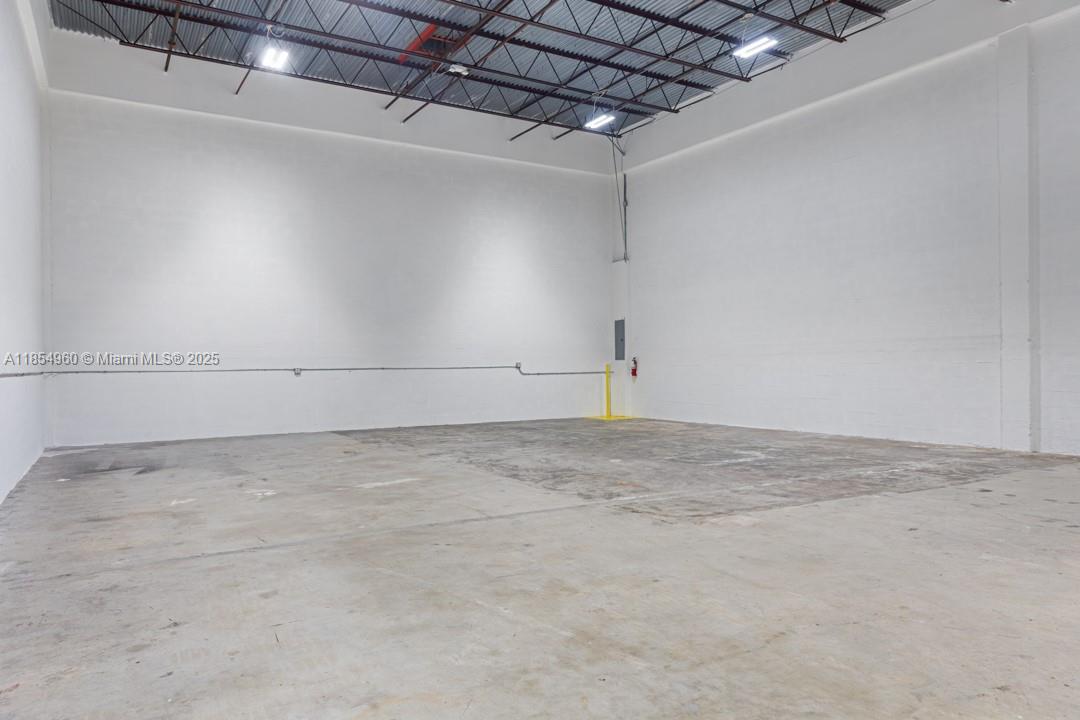 This is an empty industrial warehouse space with white walls and a concrete floor — 1501 NW 82nd Ave, Doral FL 33126, DORAL, FL