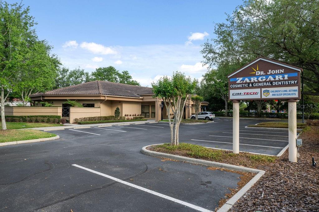 A single-story commercial building with a parking lot and a prominent professional signage sign — 2658 MAGUIRE ROAD, OCOEE, FL