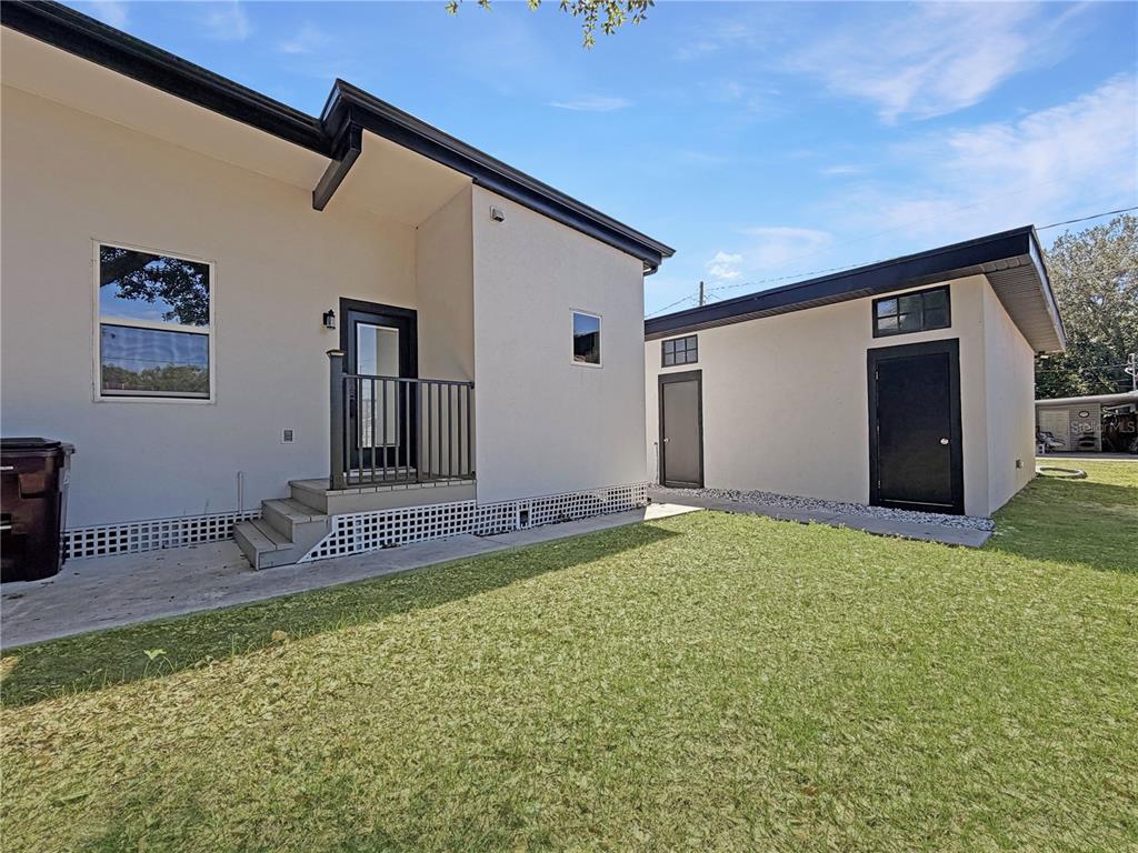 The exterior view shows a house with a small porch and a detached garage — 706 NEW YORK AVENUE, ST CLOUD, FL