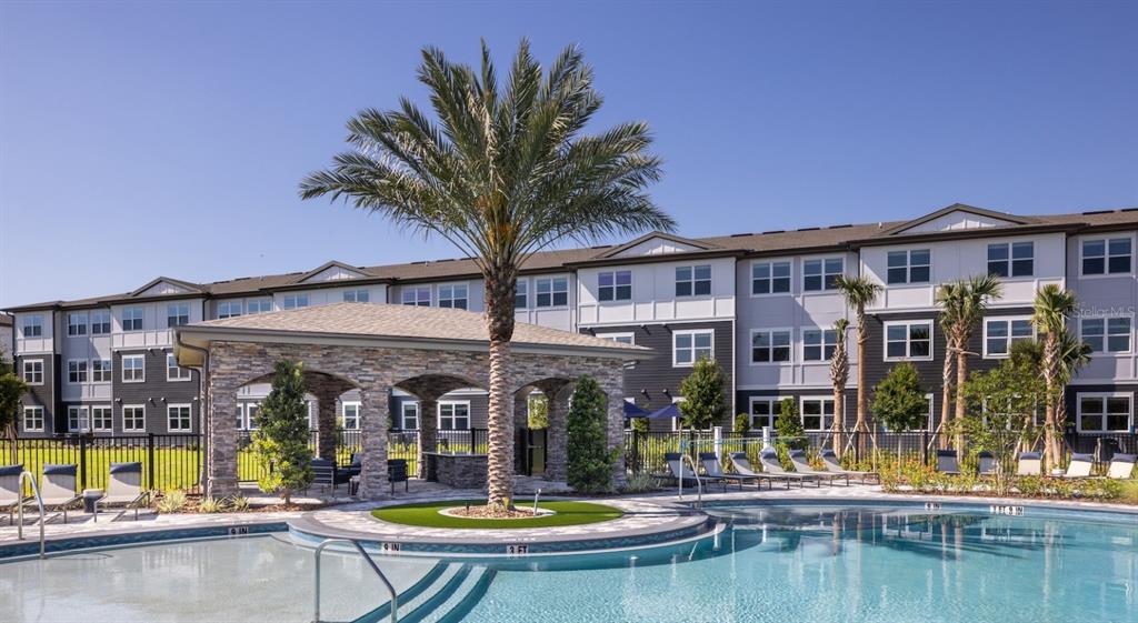 A swimming pool with a stone-pillared gazebo and a palm tree in the center — 3110 GOWAN DRIVE UNIT B1, WINTER HAVEN, FL