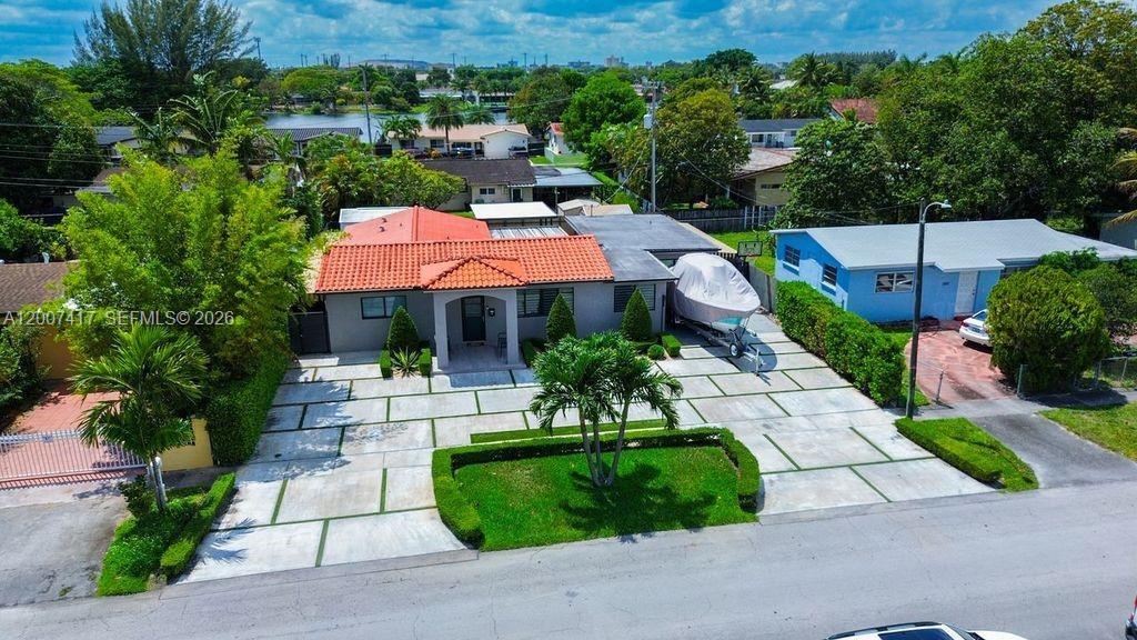 An aerial view shows a house with a red tile roof and a large driveway — 4210 W 6th Ave, Hialeah FL 33012, HIALEAH, FL