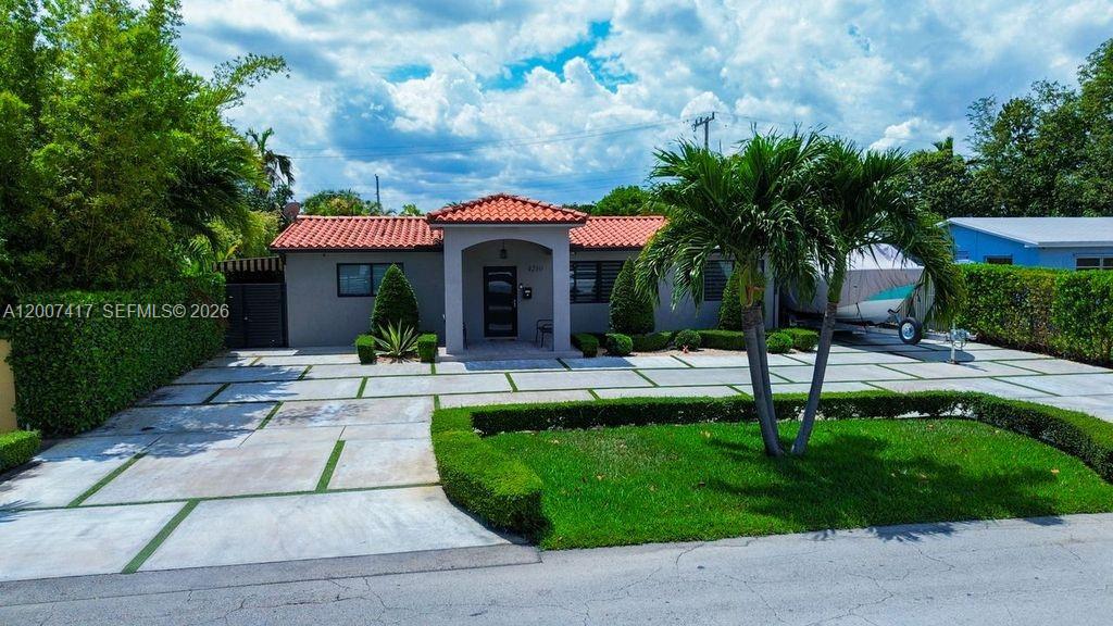 A single-story house features a red tile roof, a paved driveway, and a palm tree — 4210 W 6th Ave, Hialeah FL 33012, HIALEAH, FL