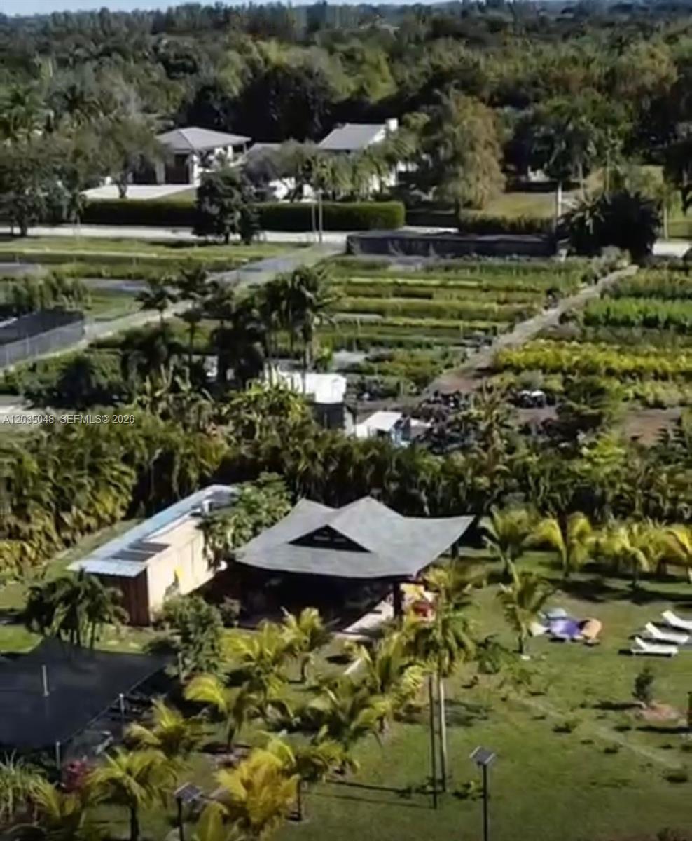 An aerial view shows a house with a large roof next to a plant nursery — 6560 SW 189th Way, Southwest Ranches FL 33332, SOUTHWEST RANCHES, FL