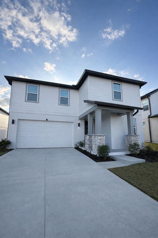 An open-concept living room and kitchen feature a large sectional sofa and marble-topped tables — 2252 GOLD SUMMIT STREET, MINNEOLA, FL