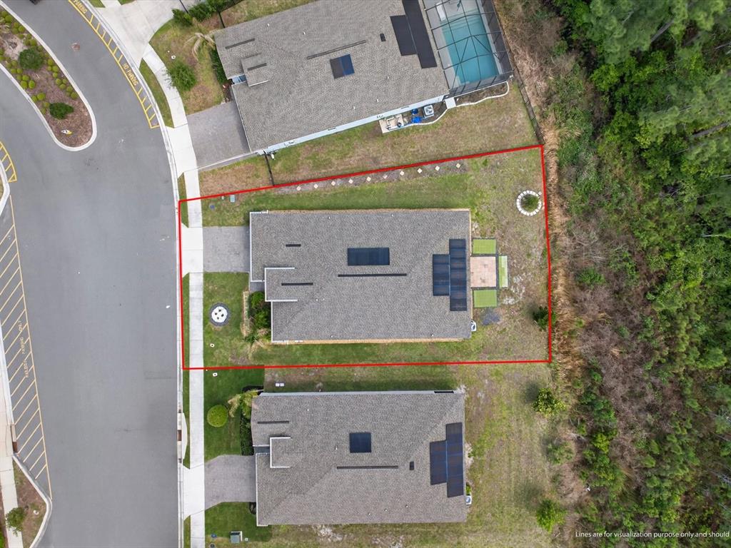 A single-story house with a white exterior, stone accent wall, and a two-car garage — 2894 CAMDEN WAY, DAVENPORT, FL