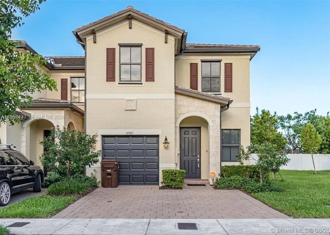 A two-story suburban home features a paved driveway, a garage, and a front entryway — 10301 W 32nd Ln, Hialeah FL 33018, HIALEAH, FL