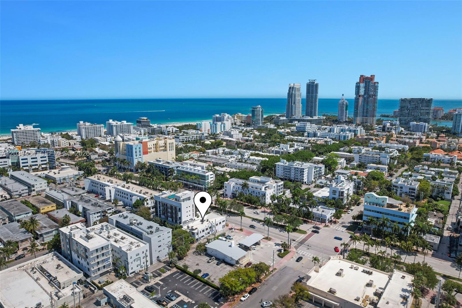 An aerial view shows a city neighborhood with a marked building near the ocean — 819 5th St, Miami Beach FL 33139, MIAMI BEACH, FL