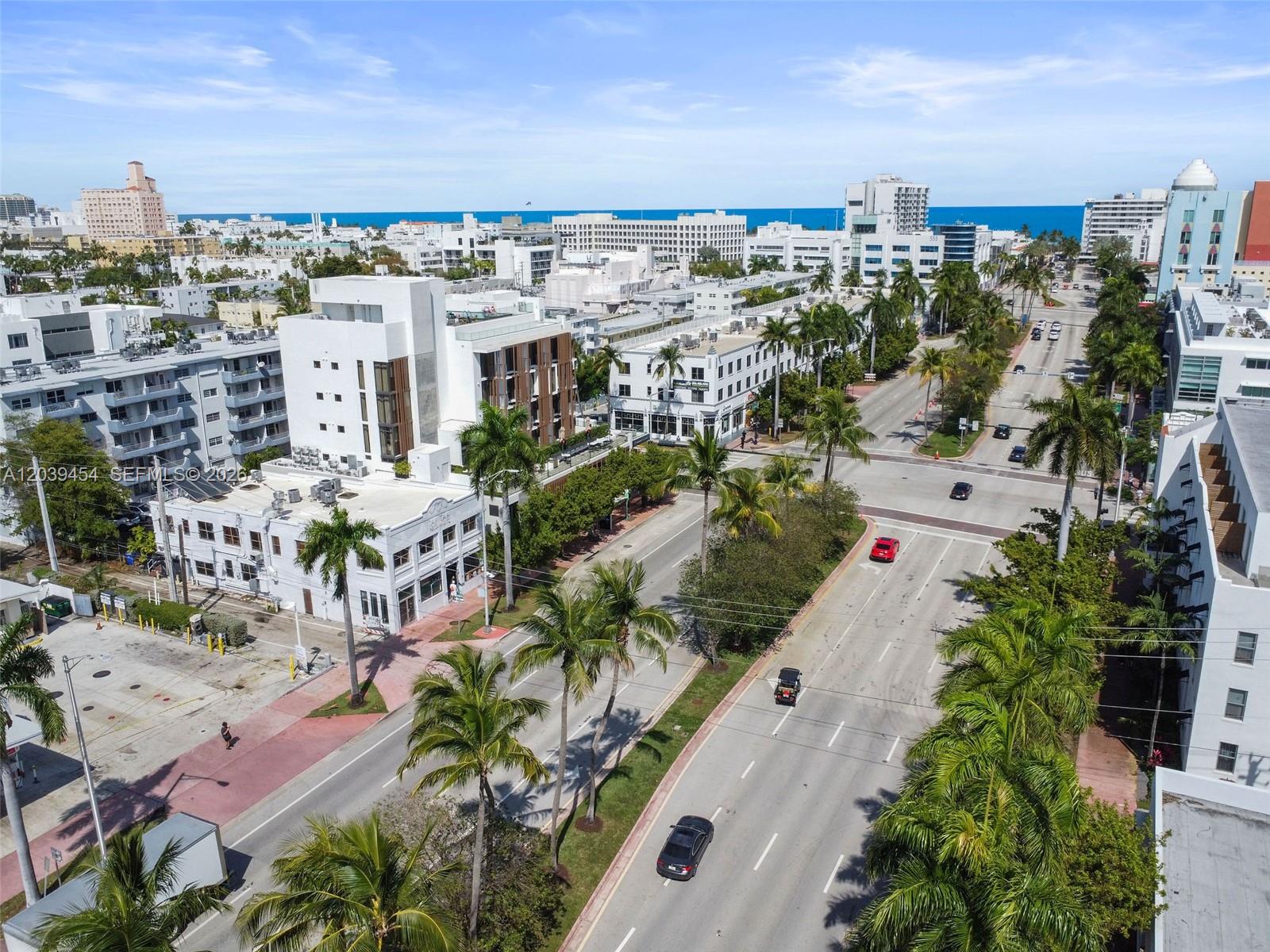 An aerial view shows a city street lined with palm trees and multi-story buildings — 819 5th St, Miami Beach FL 33139, MIAMI BEACH, FL